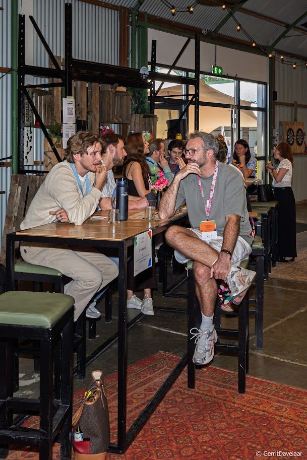 Kees talking with social entrepreneur Roel Schatorje at a high table during the Social Enterprise NL member event