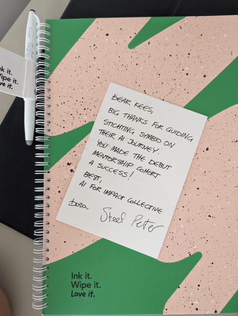 Handwritten thank-you card from the AI for Impact Collective founders on a notebook
